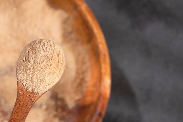istock Lepidium meyenii - Maca powder in wooden spoon 1223534288