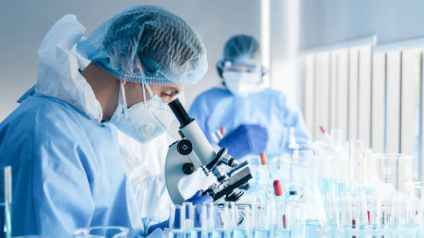 istock biochemical research scientist team working with microscope for coronavirus vaccine development in pharmaceutical research labolatory 1223535085