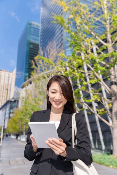 istock asian woman who see a tablet computer 1223535953