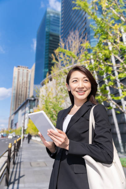 istock asian woman who see a tablet computer 1223535963