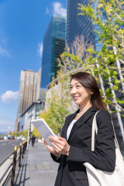 istock asian woman who see a tablet computer 1223535972