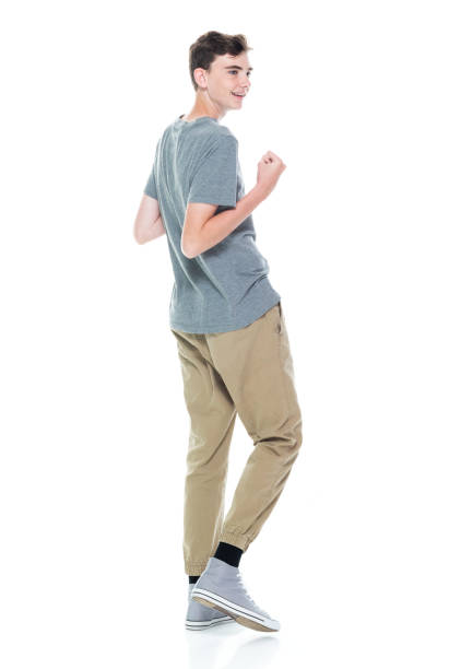 istock Caucasian young male walking in front of white background 1223536949