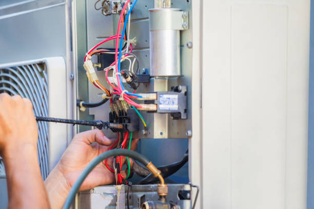 istock Male technician hands using a screwdriver fixing modern air conditioner, repairing and servicing, Maintenance and repairing concept 1223539366