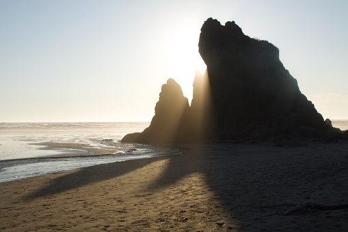 Sunset from behind rocks at Ruby Beach in Olympic National Park Washington