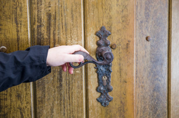 istock the hand slowly opens the ancient door with the handle 1223541326