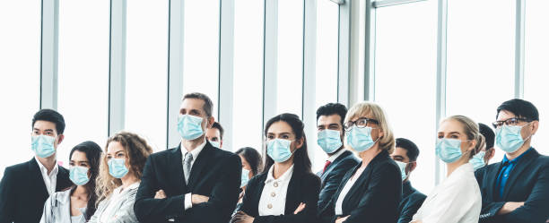 Confident business people with face mask protect from Coronavirus or COVID-19.