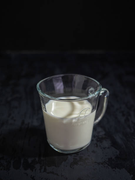 istock Glass mug of milk on a black background, space for text 1223544764