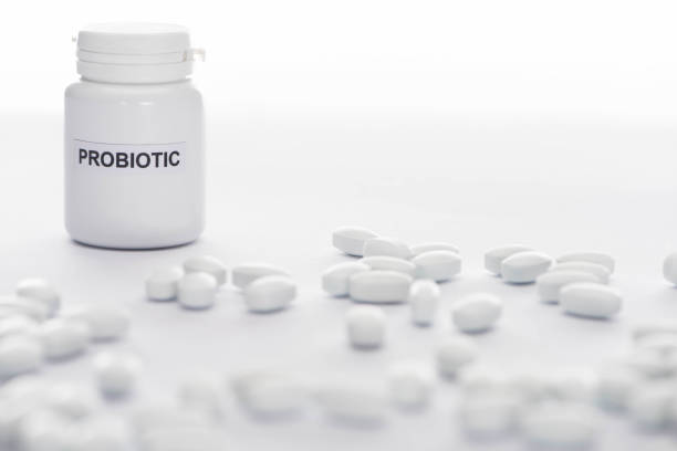 istock selective focus of probiotic container near pills on white background 1223548764