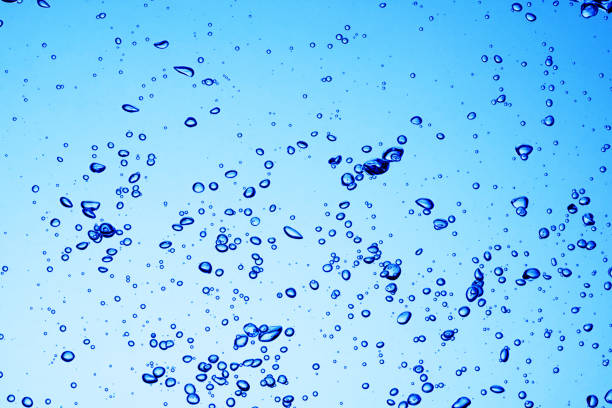 istock Bubbles of air under blue water background 1223549059
