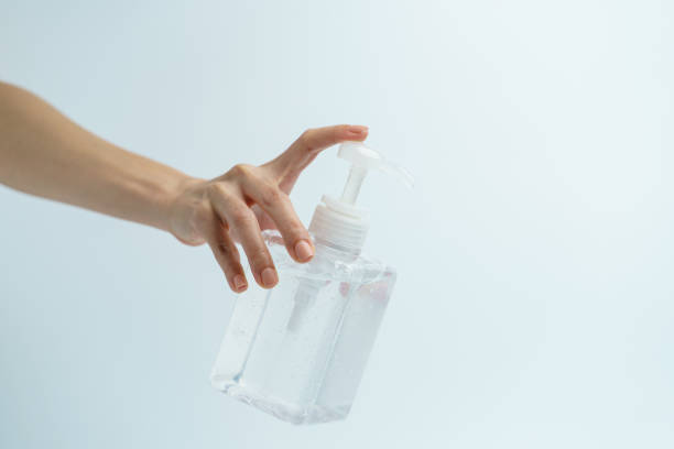istock Hand with hand sanitizer in a clear pump bottle on a white background. 1223549231