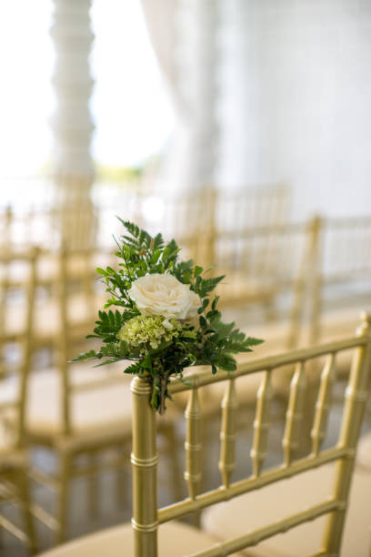 istock Flower decoration on chairs for garden wedding ceremony 1223560316