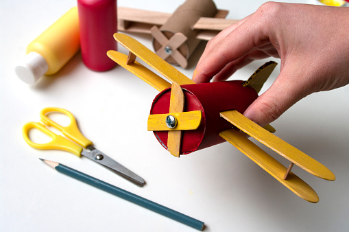 How to make airplane. Hand made toy,zero waste from toilet paper roll and popsicle sticks. Modeling. Step 21 put all details of aircraft together. DIY for child, ideas to make during home quarantine.