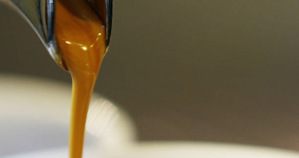 istock Macro of a professional coffee machine making hot espresso coffee in a transparent cup 1223563143