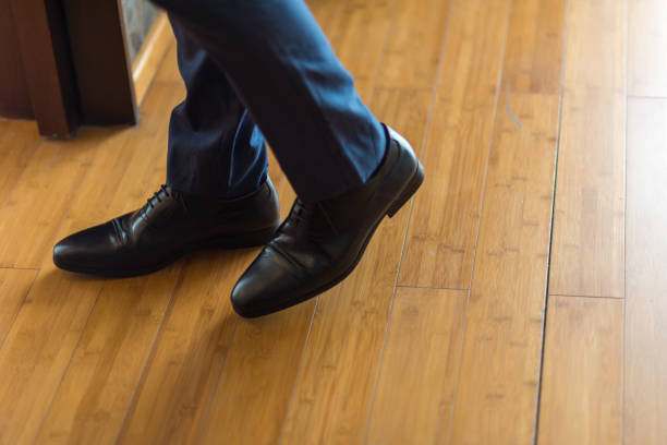istock Man in formal suit wearing black leather shoe 1223563803
