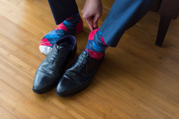 istock Bridegroom putting on a black leather shoe 1223563804