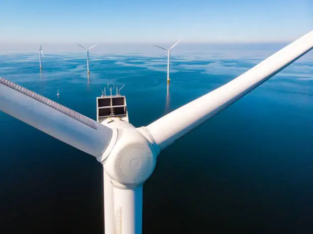 Wind turbine from aerial view, Drone view at windpark westermeerdijk a windmill farm in the lake IJsselmeer the biggest in the Netherlands,Sustainable development, renewable energy, drone view