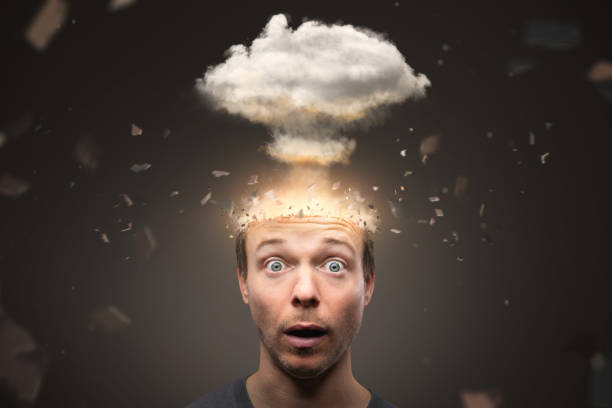 Portrait of a man with an exploding mind A man looking into the camera with a shocked expression. The top of his head is exploding in a non cruel way. A mushroom cloud is rising above the head. head stock pictures, royalty-free photos & images