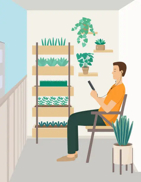 Vector illustration of A young man sits sideways in a chair and looks at a tablet. A person on the balcony with headphones, listening to music or reading.