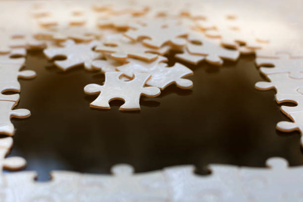 istock Close the white jigsaw puzzle with many options, with text space. 1223568614