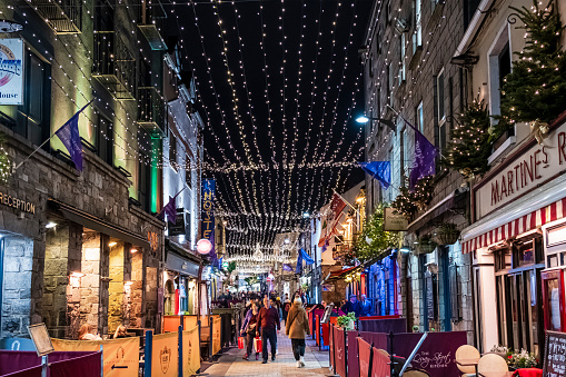 People strolling under Christmas decorations in downtown Galway, a city in the West of Ireland.