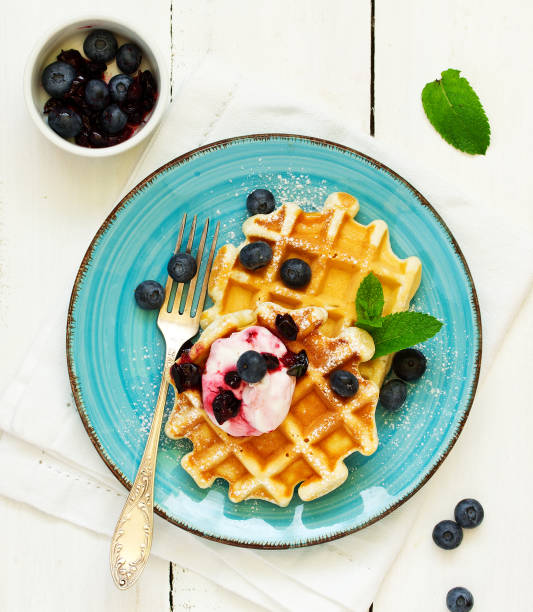 istock Homemade waffles with a sprig of currants. White background. 1223574482
