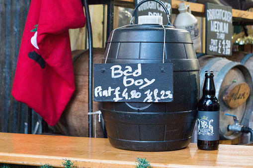 Bad Boy Cider in Borough Market, London, with logo and label visible on the counter, on the beer bottle