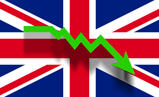 Green graphic arrow moving down on Britain flag. Horizontal composition with copy space. Economy and finance concept