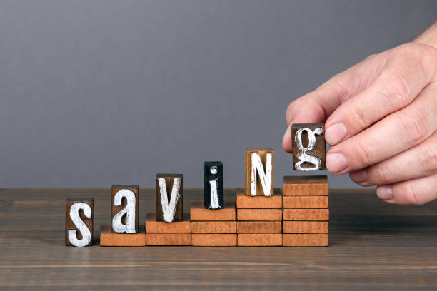 istock SAVING concept. Wooden alphabet letters on steps 1223582983