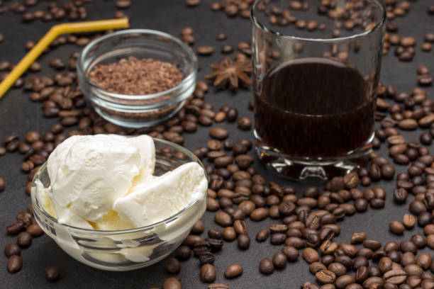 istock Ice cream and Glass with coffee. Coffee beans scattered on table. 1223584929