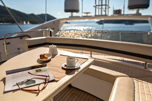 Gocek, Turkey, October 28, 2015 : Luxury Traveling. Interior of Modern Motor Yacht,Magazine ,Croissant and Coffee on the Table