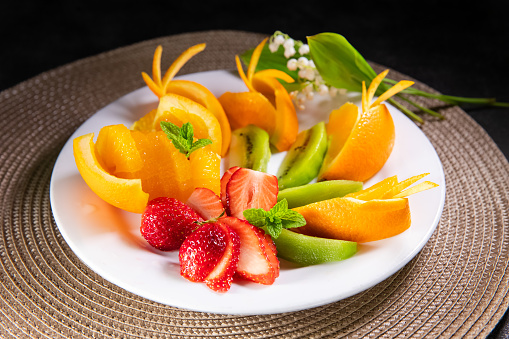 Fresh, organic fruits, light snacks in a plate
