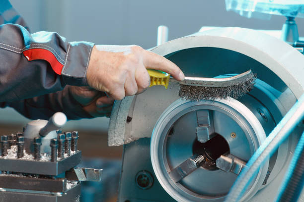 a worker is cleaning a steel part - ncc imagens e fotografias de stock