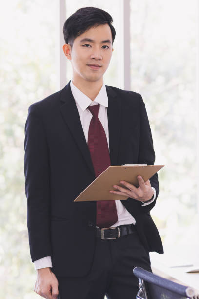 istock Asian Businessman standing and posing in office. 1223585886