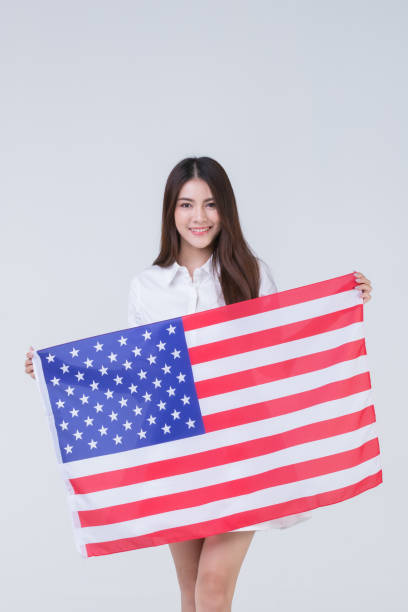 istock Asain woman holding American flag. 1223585968