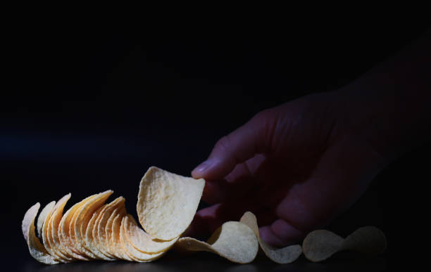 istock Potato and corn chips. Snacks and salty appetizer. Harmful products. Flavored Chips. 1223586256