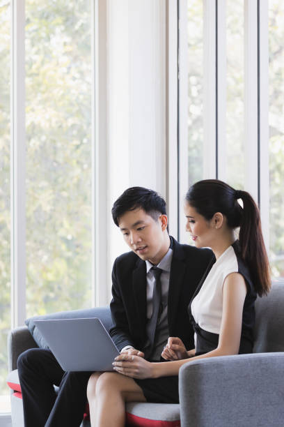 istock Asian business people using laptop in office. 1223587625