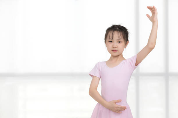 istock Pink dressed Asian girl in a ballet pose. 1223588828