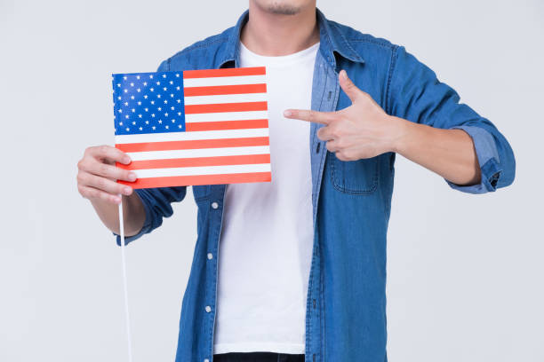 istock Man pointing to American flag. 1223589067