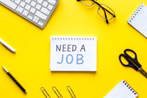 istock Need a job, looking for. Text on yellow office desk top-down flat lay 1223590295