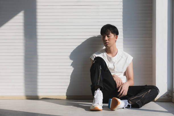 istock Sexy Asian model man sitting and facing left. 1223590442