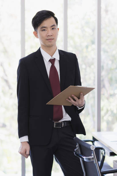 istock Asian Businessman standing and posing in office. 1223591194