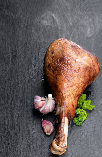 istock Roasted turkey leg on black stone background 1223591196
