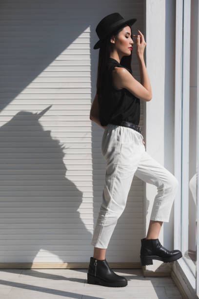 istock Asian woman clasp one's hands near window. 1223592320