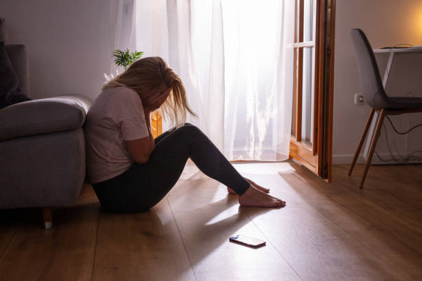 istock Sad depressed woman crying with head in hands at home during epidemic quarantine 1223592543