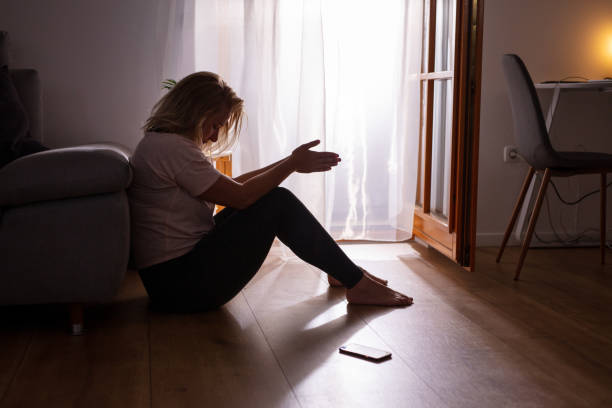 istock Sad depressed woman crying at home 1223592611
