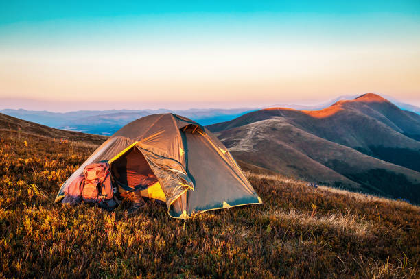 istock tent in mountains at sunrise 1223592809