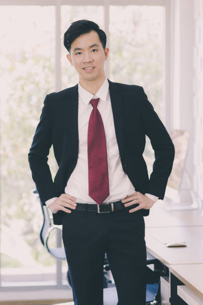 istock Asian Businessman standing and posing in office. 1223593034