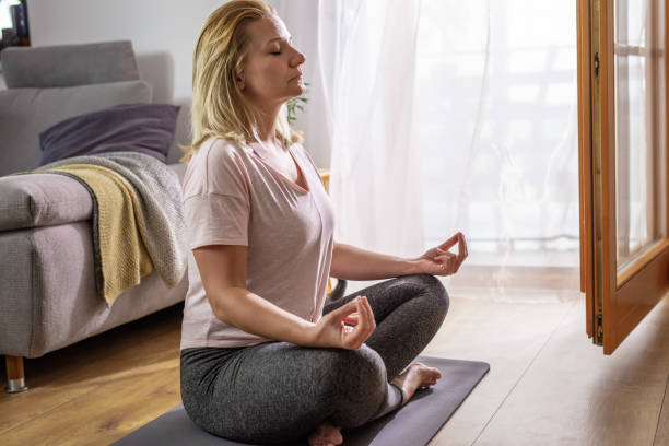 istock Woman practicing yoga at home 1223594055
