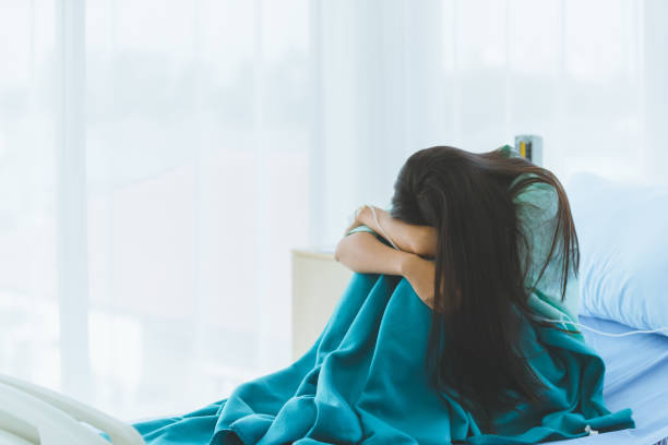 istock Female patient shows despair with her illness. 1223594095