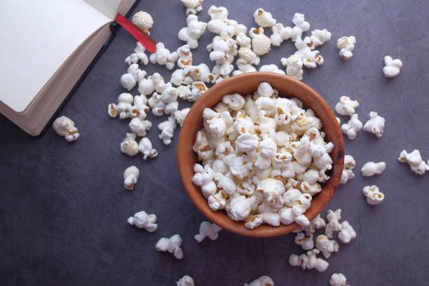 istock high angle view of popcorn and book on table 1223594283